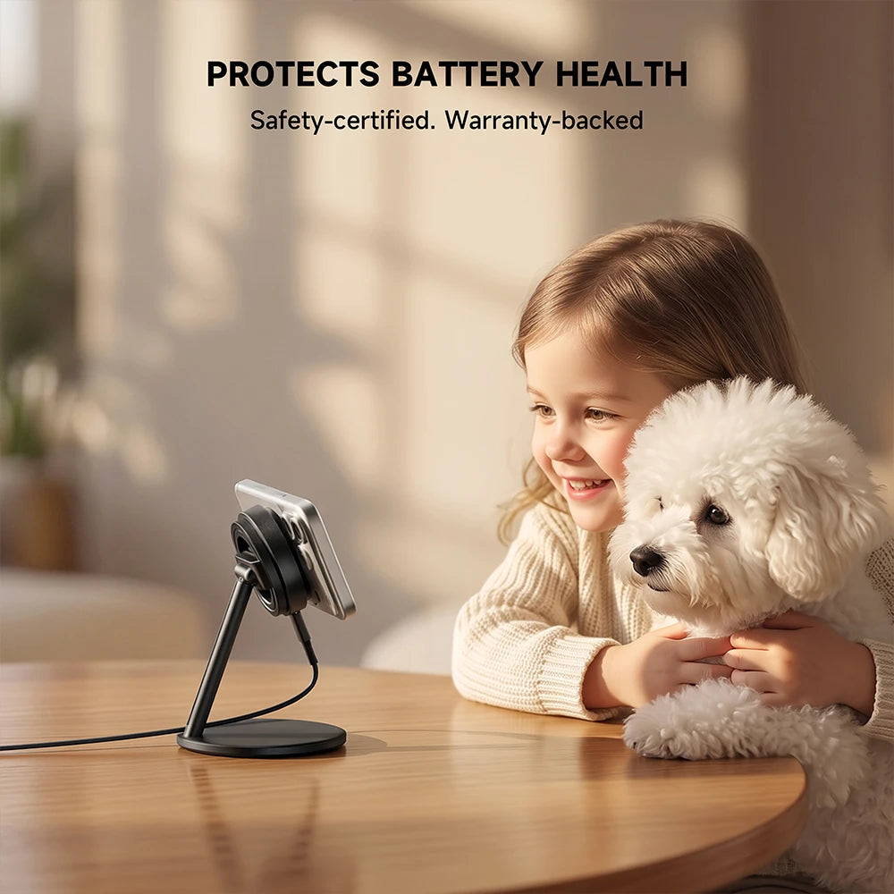 A child and a small white dog sit at a wooden table in a warm indoor setting, looking at a smartphone placed on a gray wireless charger. Text at the top reads "PROTECTS BATTERY HEALTH" and "Safety-certified." #color_gray