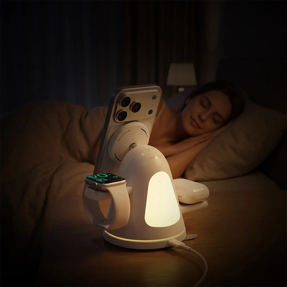 A woman sleeping in bed, with a ZEEHOO LuminoCore on the nightstand. A smartphone and smartwatch are placed on the wireless charging stand, while its built-in rear night light provides soft ambient illumination.