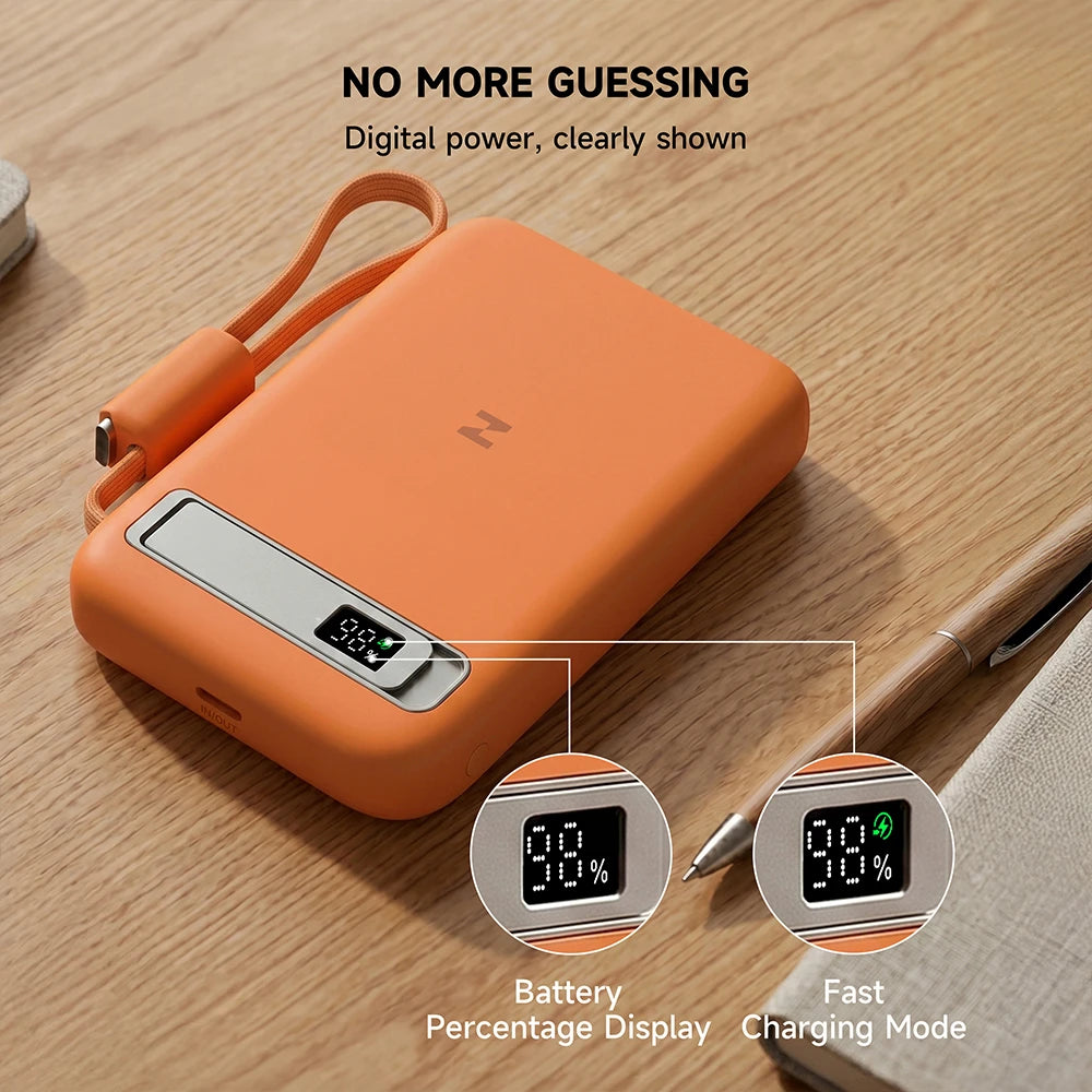 Orange MagAir semi-solid-state power bank with a digital display on a wooden surface. #color_orange