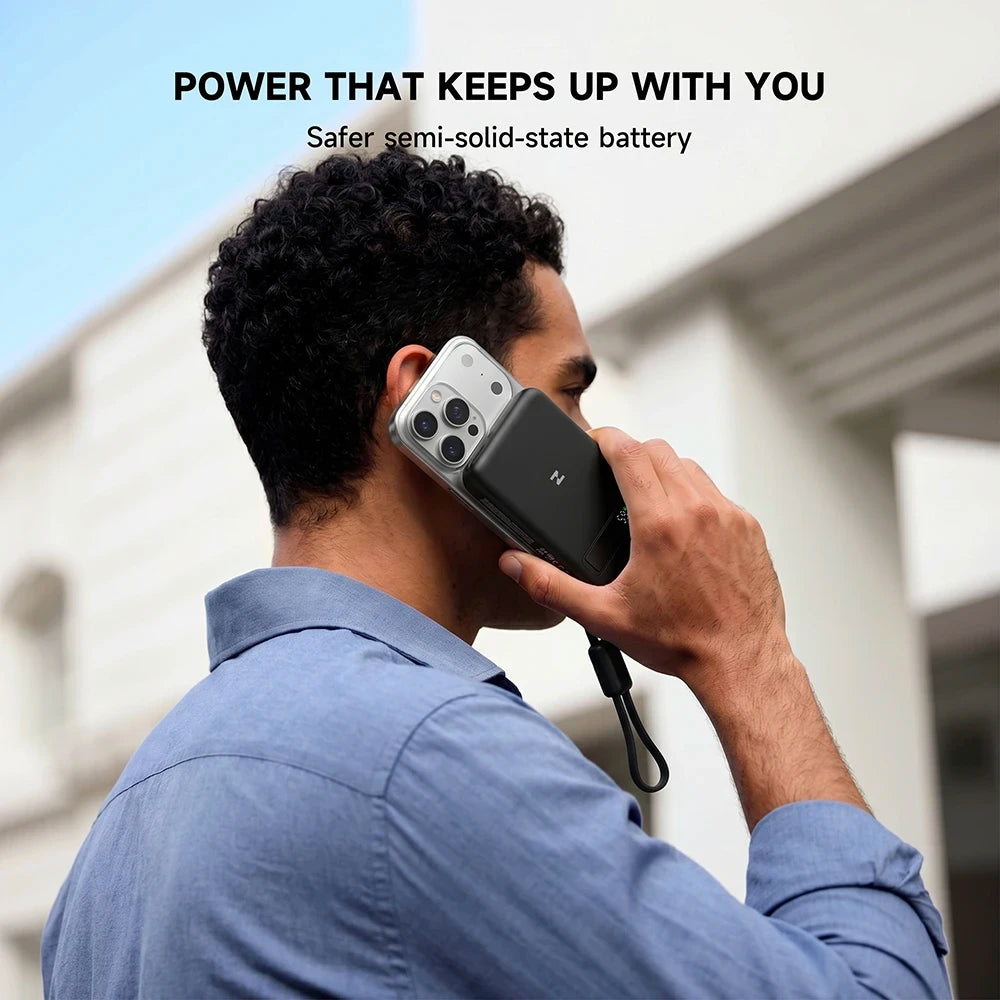 Person holding a smartphone with a MagAir semi-solid-state magnetic power bank, highlighting semi-solid-state battery technology. #color_black