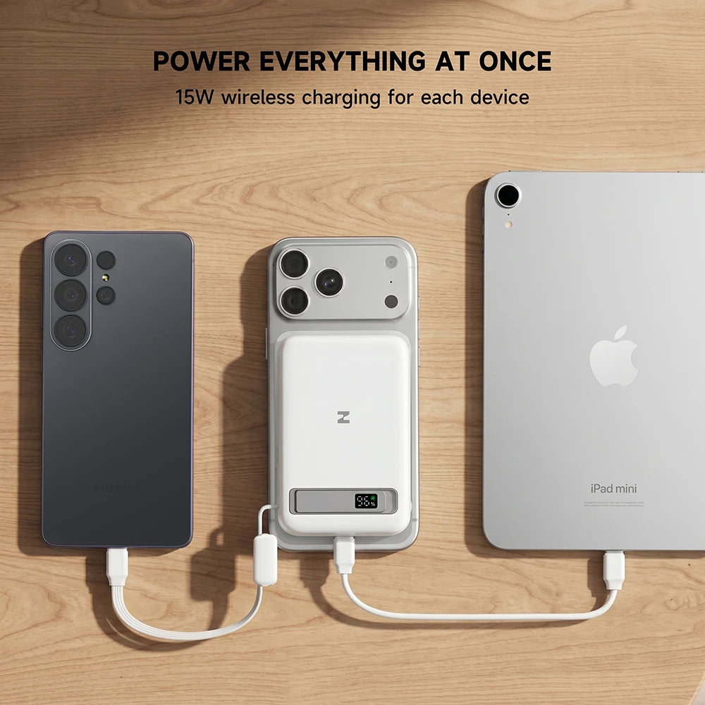 Wireless charging pad powering three devices on a wooden surface, featuring 15W wireless charging for each device. #color_white