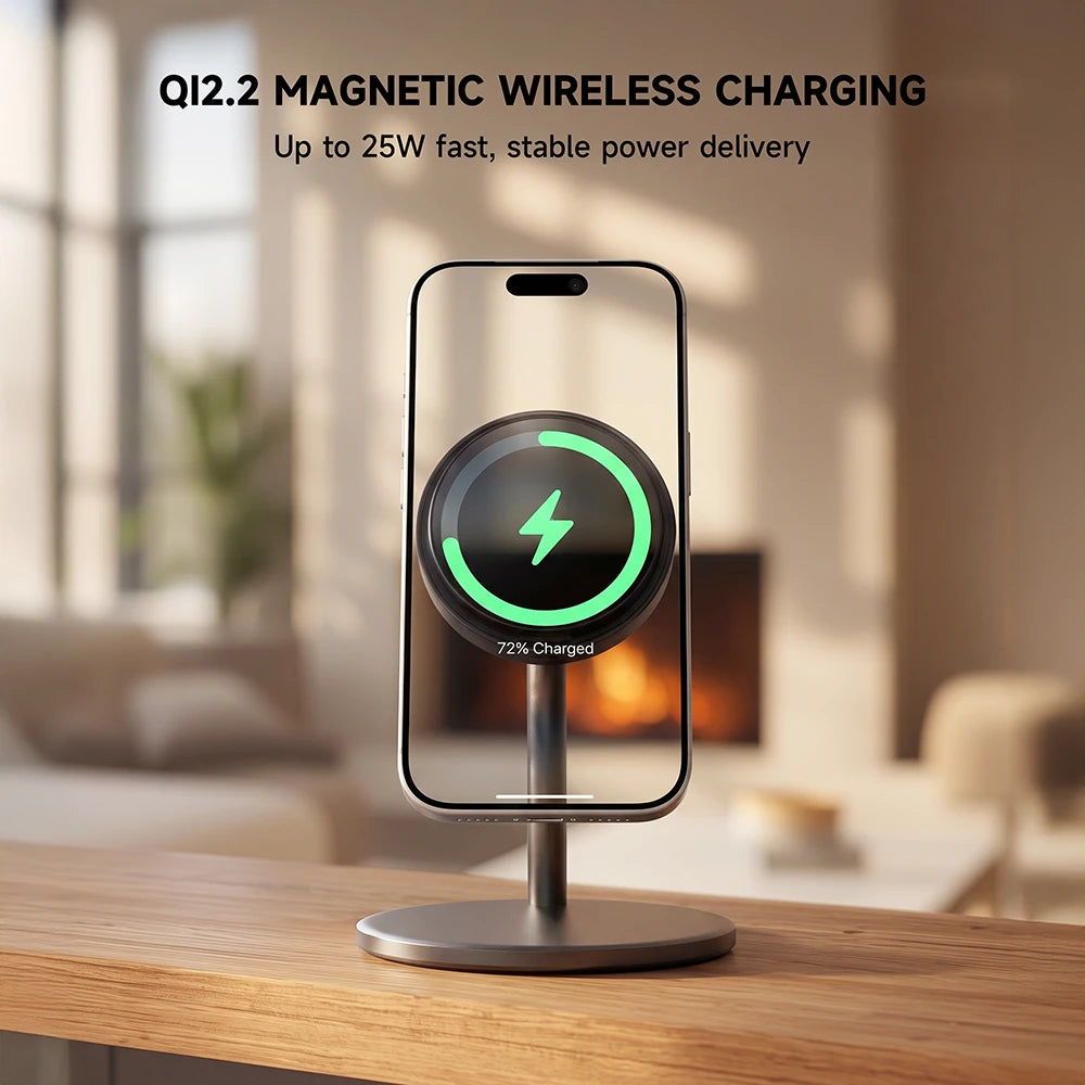 A magnetic wireless phone charger on a wooden table in a softly blurred living room setting, with a smartphone centered on the charging pad and text at the top reading 'Q2.2 MAGNETIC WIRELESS CHARGING' and 'Up to 25W fast, stable power delivery.  #color_gray