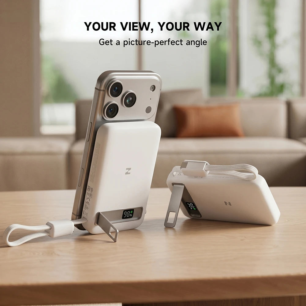 A smartphone propped up by the built-in stand of a MagAir semi-solid-state power bank on a table, featuring the slogan “Your View, Your Way.” #color_white