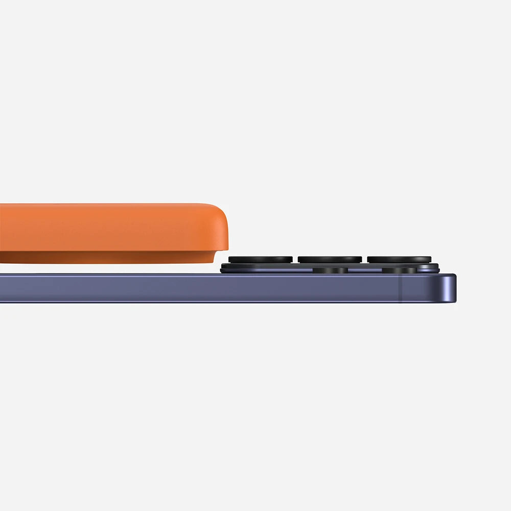 Orange MagAir semi-solid-state magnetic power bank with a raised wireless charging module for compatibility with smartphones featuring different camera bump designs.
