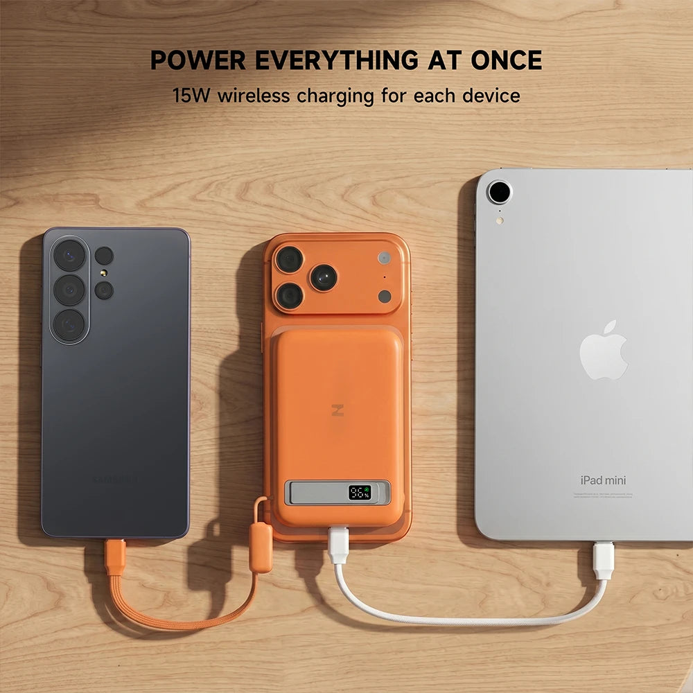 Orange MagAir semi-solid-state power bank wirelessly charging devices on a wooden surface. #color_orange