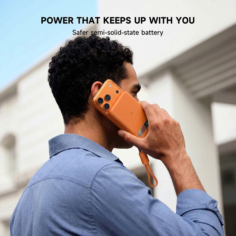 Person holding an orange MagAir semi-solid-state power bank with battery safety messaging. #color_orange