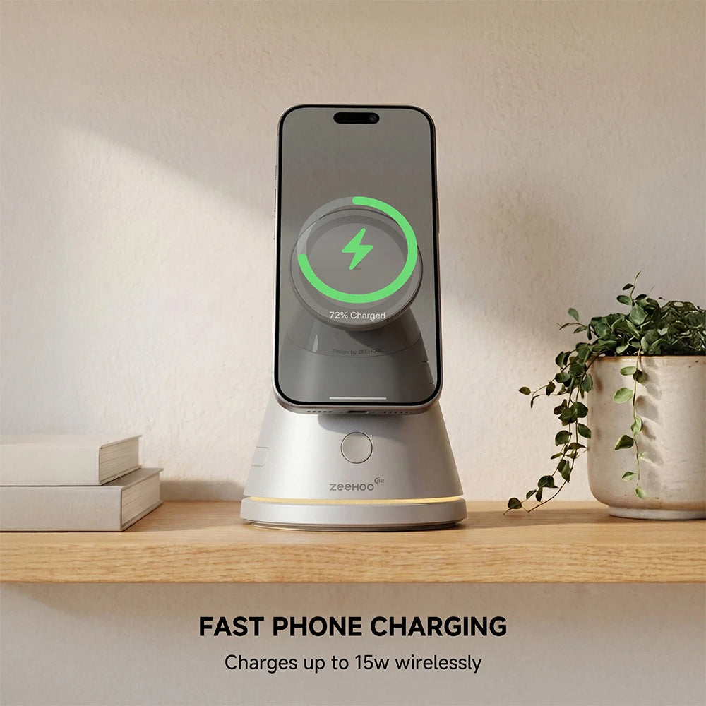ZEEHOO LuminoCore gray 4-in-1 wireless charging stand holding a smartphone on a wooden shelf, styled with a plant and books in the background. #color_gray