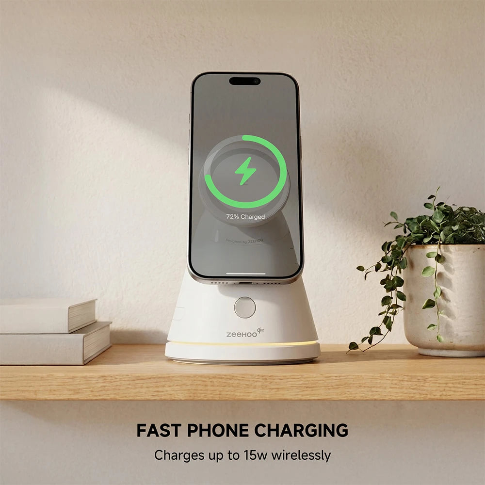 ZEEHOO LuminoCore white 4-in-1 wireless charging stand holding a smartphone on a shelf, styled with a plant in a modern interior. #color_white