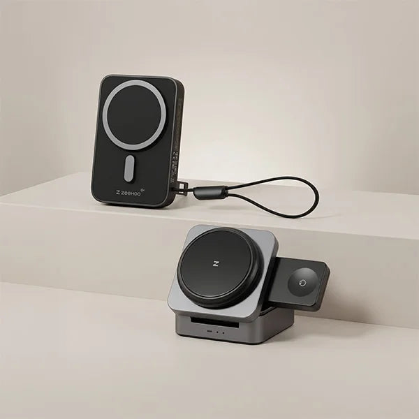 ZEEHOO black solid-state power bank and gray FoldTrack 3-in-1 wireless charging station on a light beige surface.